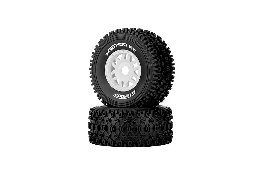 Two Method RC 2.3 Geoform all-terrain tires mounted on white 12-spoke rims, shown stacked against a white background.