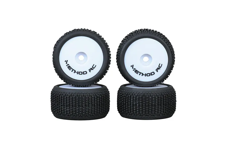 Four Method RC 1/28 scale NitraGrip tires mounted on white aero wheels, shown in a studio product shot.