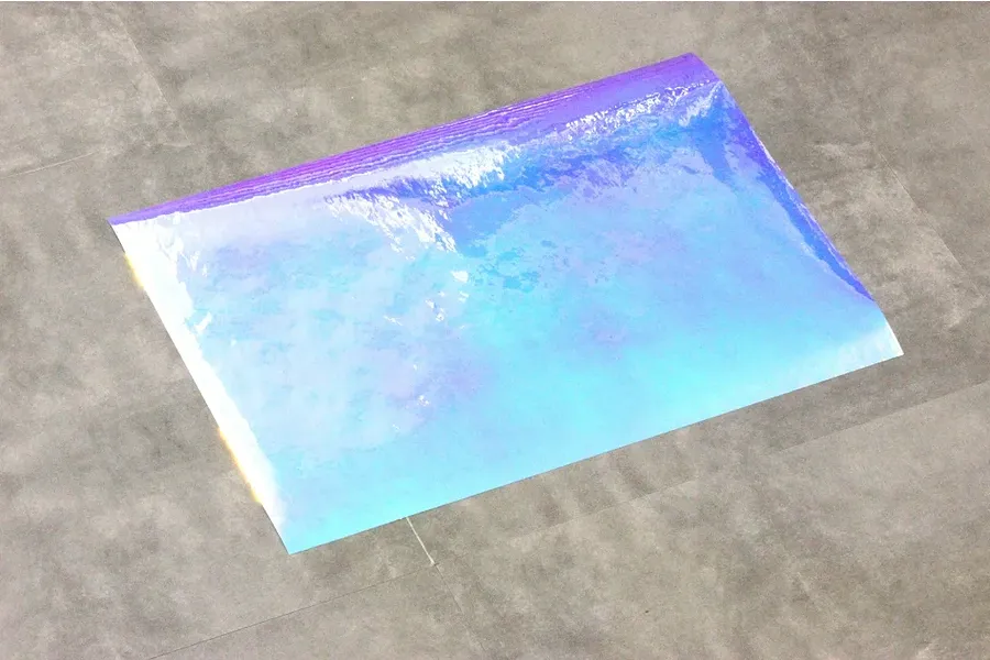 A rectangular sheet of iridescent blue Aurora window sticker material for RC car bodies, shown against a grey background.