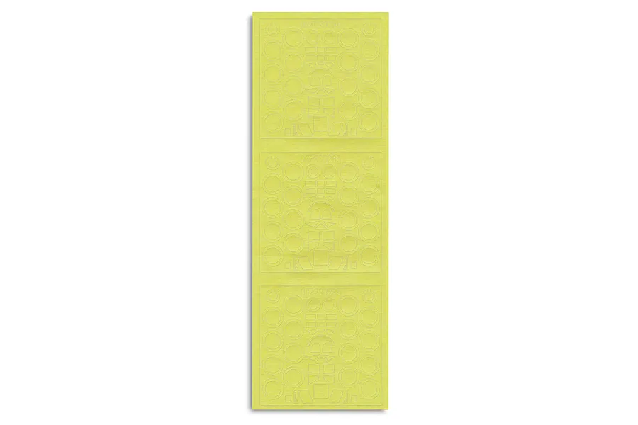 A sheet of yellow adhesive masking tape for a model kit, featuring pre-cut circular and geometric shapes for painting details.