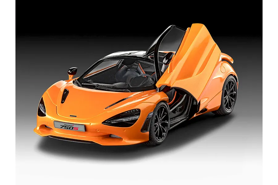 A studio shot of a 1/24 scale Revell McLaren 750S plastic model car in bright orange with dihedral doors open.