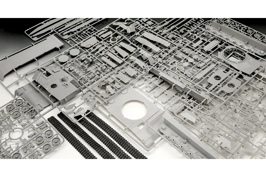 Grey plastic model kit sprues and black rubber tank tracks for a 1/35 scale Leopard 2A7A1 tank model.