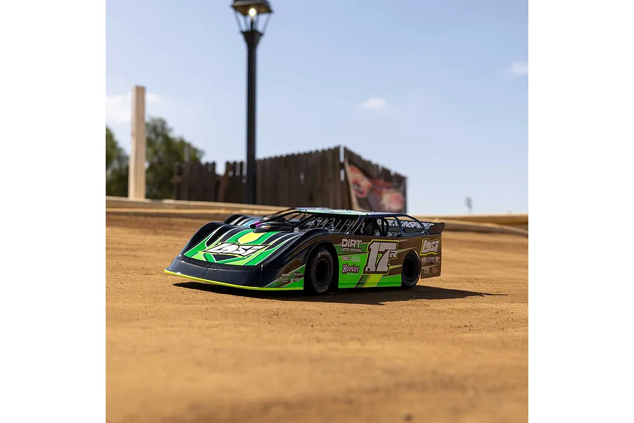 A Losi 22S Dirt Late Model RC car in green and black livery sitting on a dirt track outdoors.