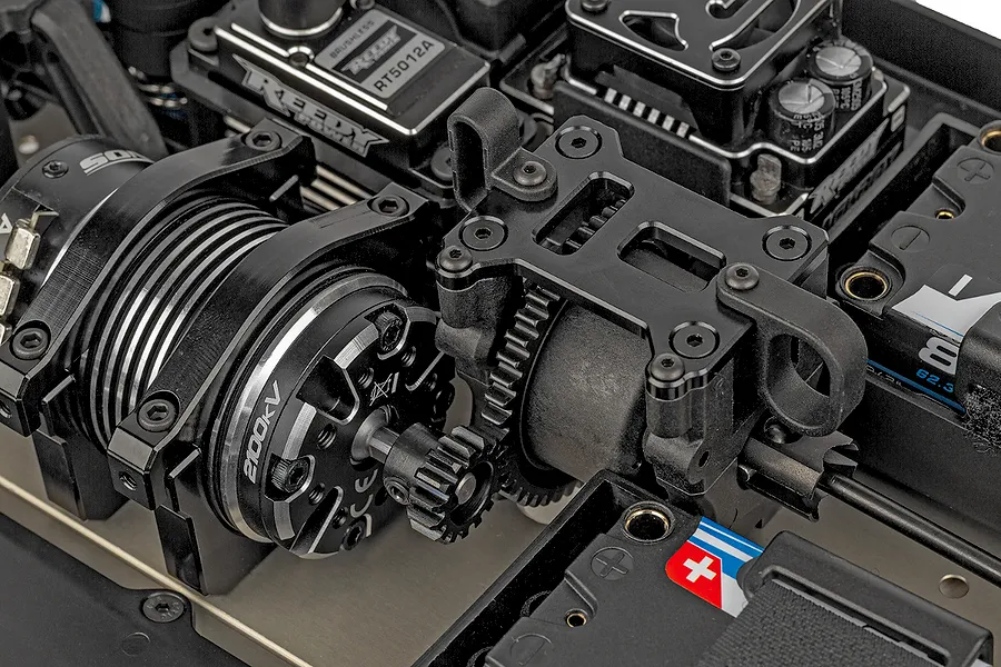 Close-up of the electric motor and center differential assembly inside a Team Associated RC8T4.2e RC truggy chassis.