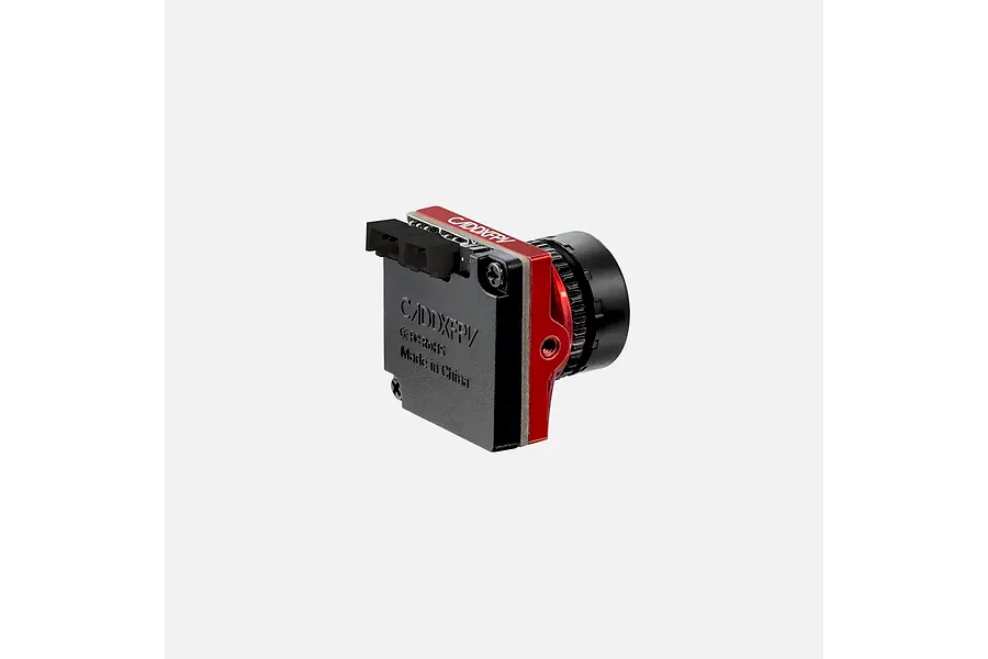 CaddxFPV Ratel 2 analog FPV camera in red, shown from a side-rear angle against a plain light grey background.