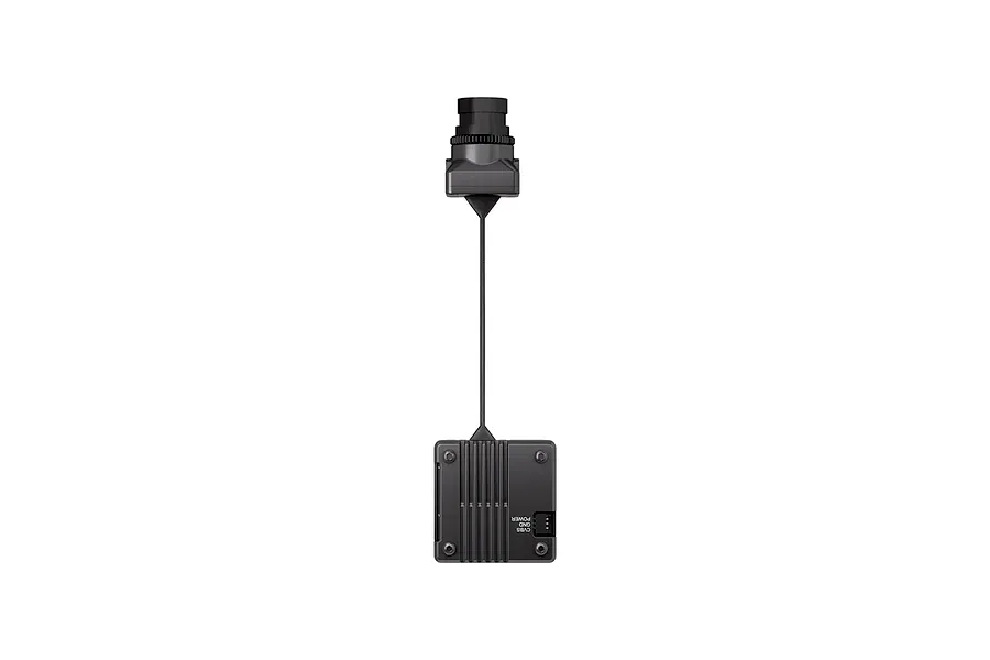 CaddxFPV Infra Red V2 analog FPV camera connected to a square AI processing box by a thin black ribbon cable against a white background.