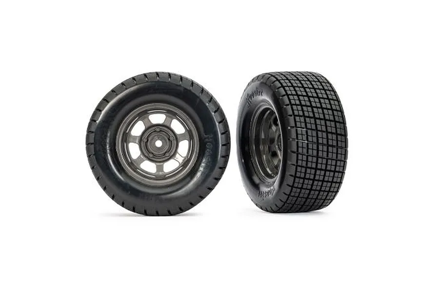 Two Traxxas 1/10 scale Hoosier dirt oval front wheels with graphite grey rims and black rubber tires against a white background.