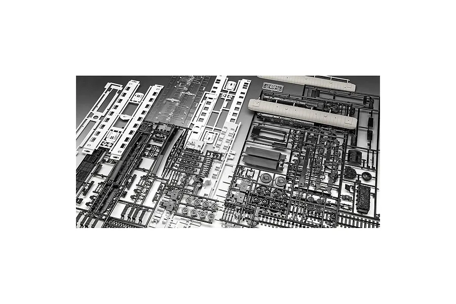 Several plastic model kit sprues for a train set, including black and white parts for carriages and locomotive components.