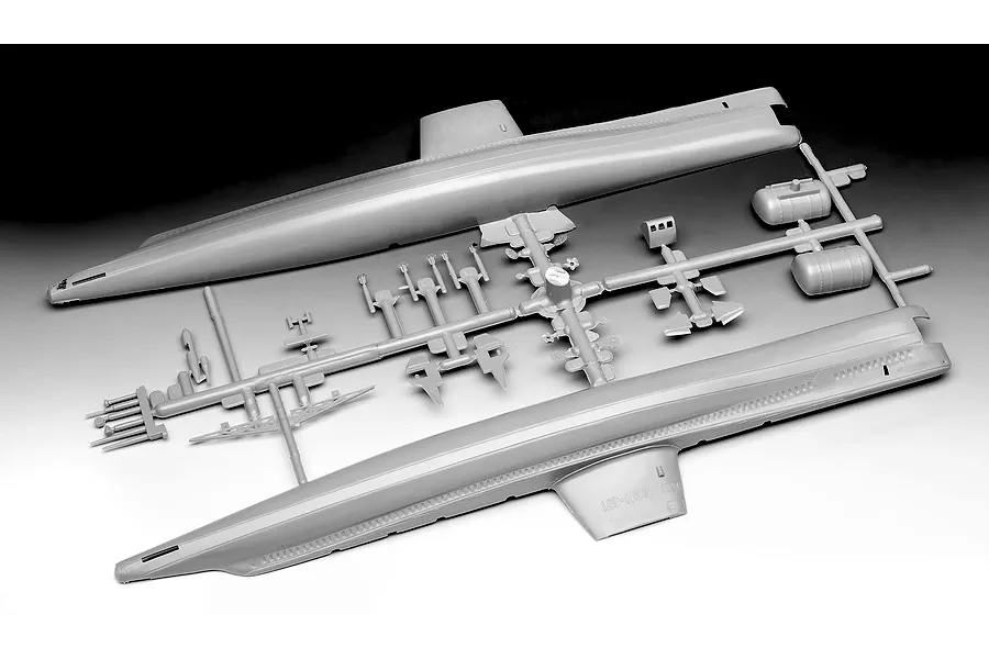 Unassembled grey plastic model kit parts for a U.S.S. Nautilus submarine on a sprue, including the main hull halves.