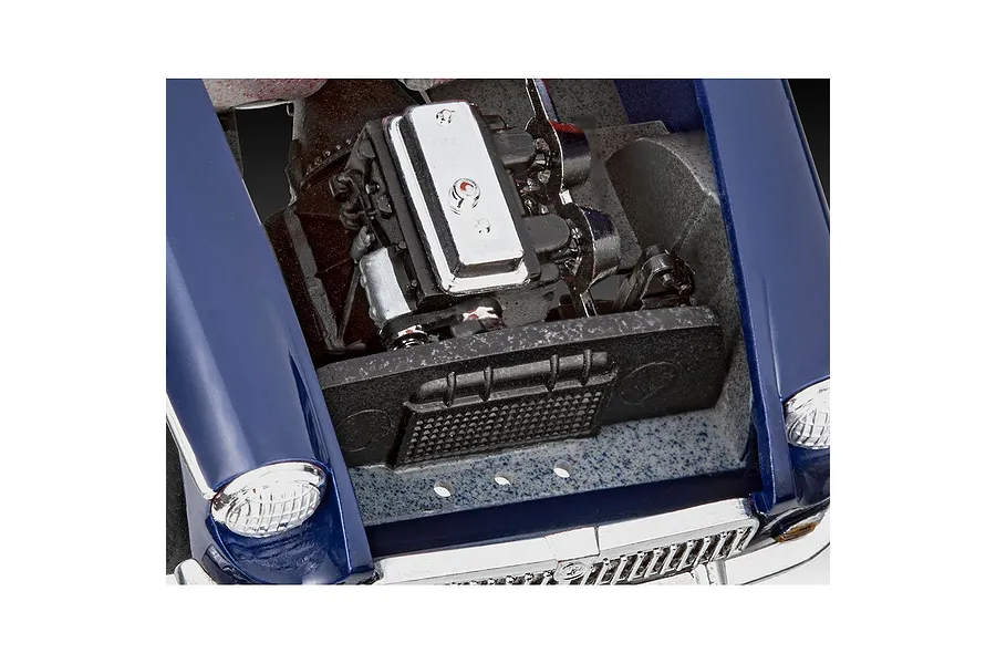 Close-up of the engine bay of a blue Revell 1/32 MGB Roadster model car kit, showing the detailed engine block and radiator.