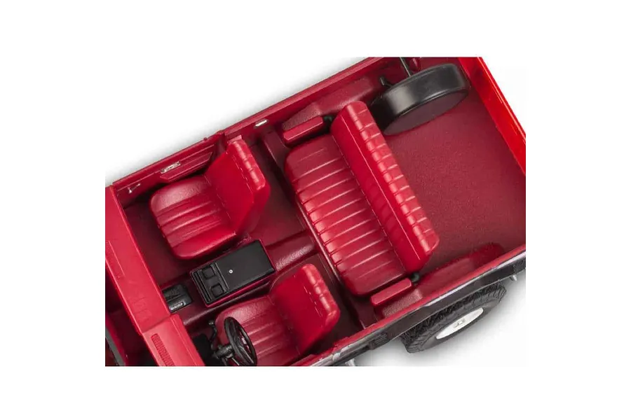Top-down view of the red interior of a 1/25 scale model GMC Jimmy, showing seats, steering wheel, and center console.