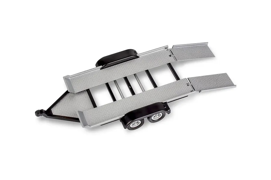 A 1/25 scale model car trailer with diamond plate deck, black fenders, and dual axles, viewed from a high angle.
