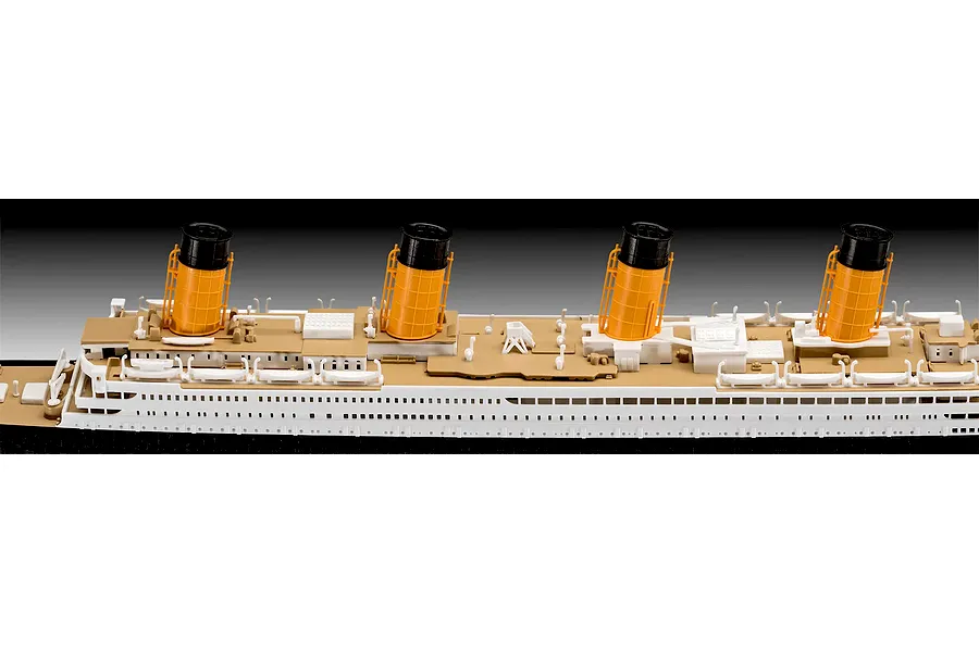 A close-up side view of a Revell 1/600 RMS Titanic model kit showing the deck, lifeboats, and four iconic yellow and black funnels.