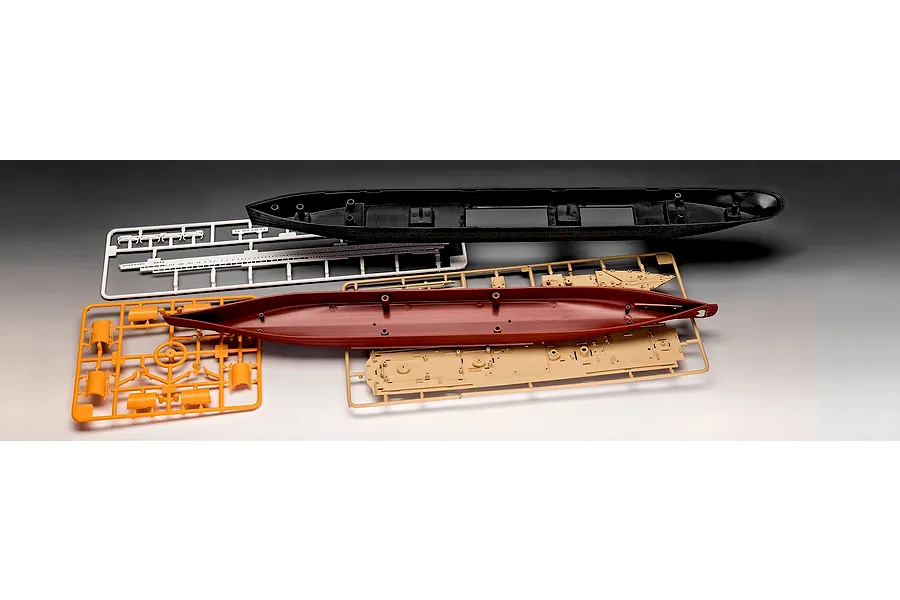 Unassembled plastic model kit parts for the Revell RMS Titanic, including hull sections and sprues in black, red, tan, white, and orange.