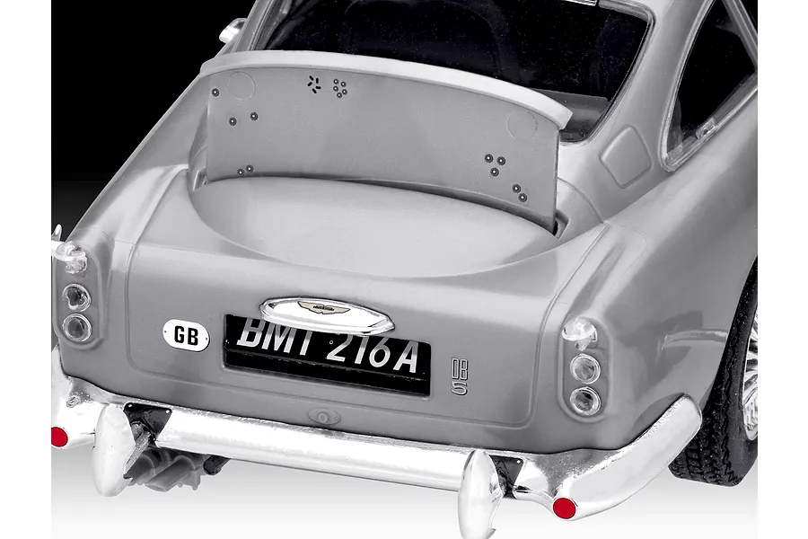 Close-up of the rear of a silver Aston Martin DB5 model car showing the license plate BMT 216A and an open rear bulletproof shield.