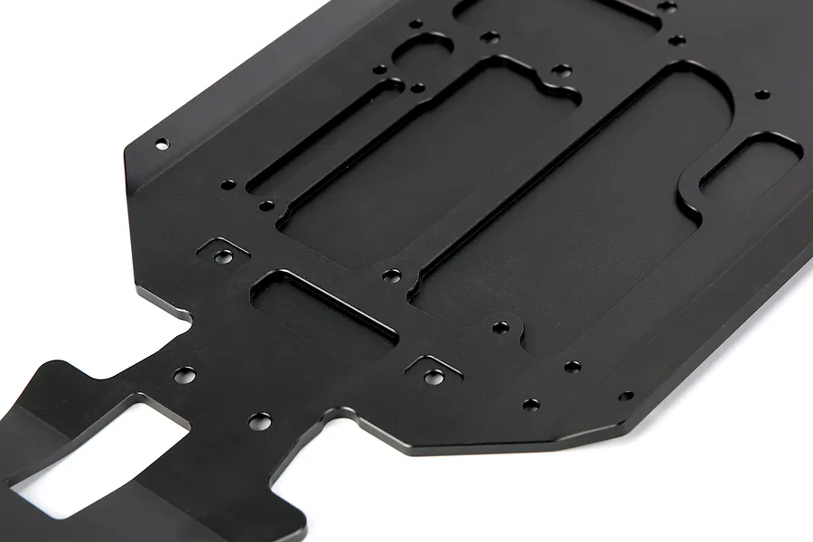 A black anodized aluminium RC main chassis plate with various mounting holes and cutouts, viewed from an angle against a white background.