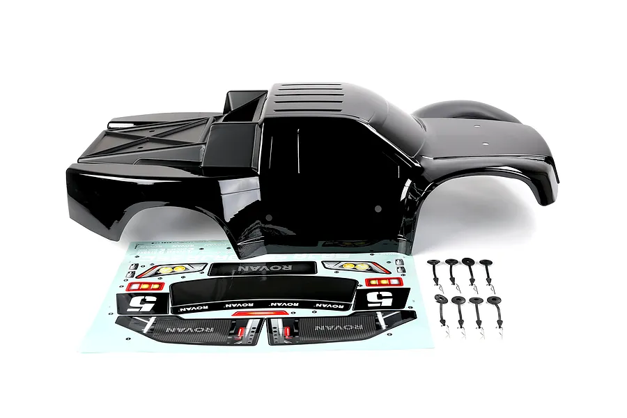 A black Rovan 1/5 scale short course truck body shell with a decal sheet and body clips on a white background.