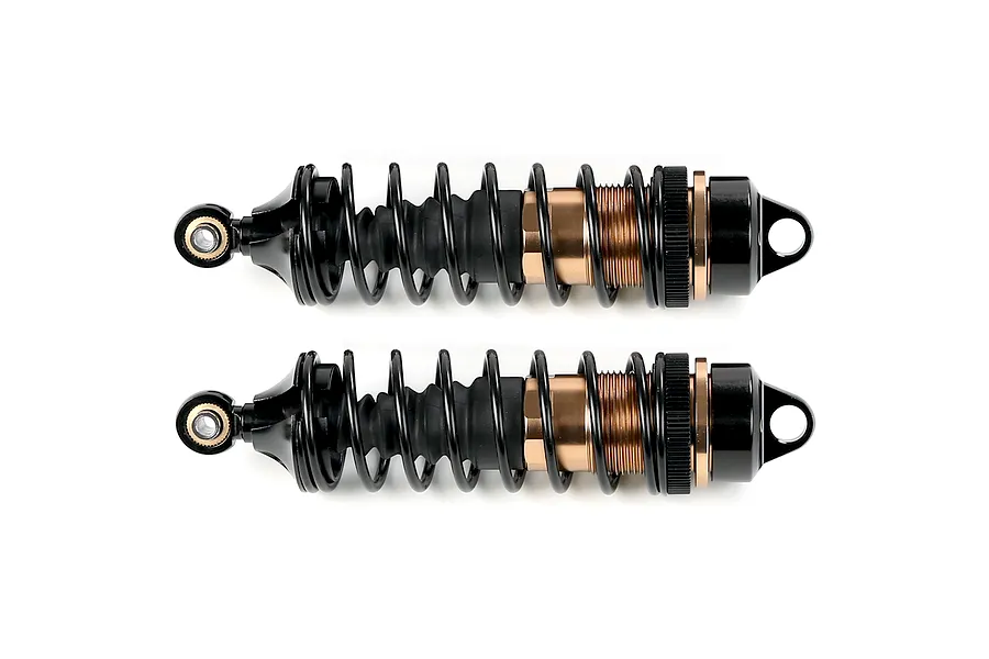 Two Rovan adjustable RC shock absorbers with bronze-coloured bodies and black springs, shown horizontally against a white background.