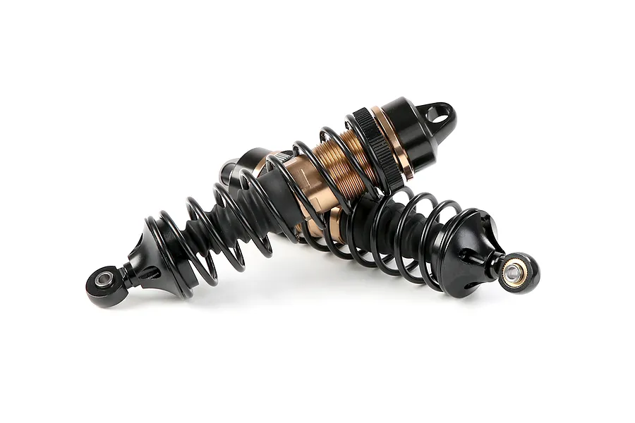 Two Rovan aluminium front adjustable RC shock absorbers in bronze and black finish, laid across each other on a white background.