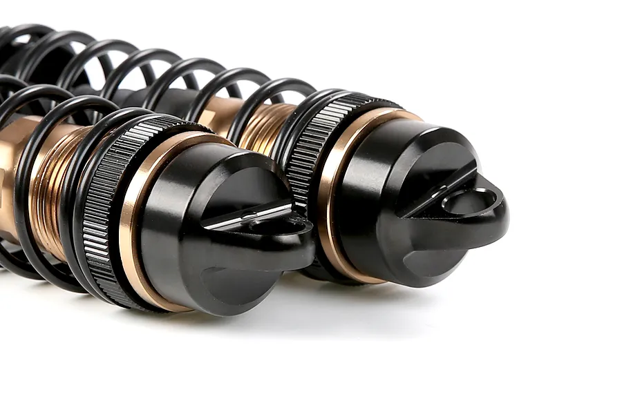 Close-up of two Rovan bronze aluminium adjustable RC shock absorbers with black springs and caps against a white background.