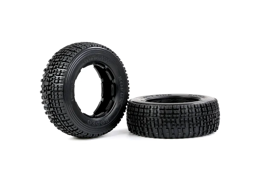 Two black Rovan 1/5 scale RC short course truck tyres with a blocky tread pattern, one standing upright and one lying flat.