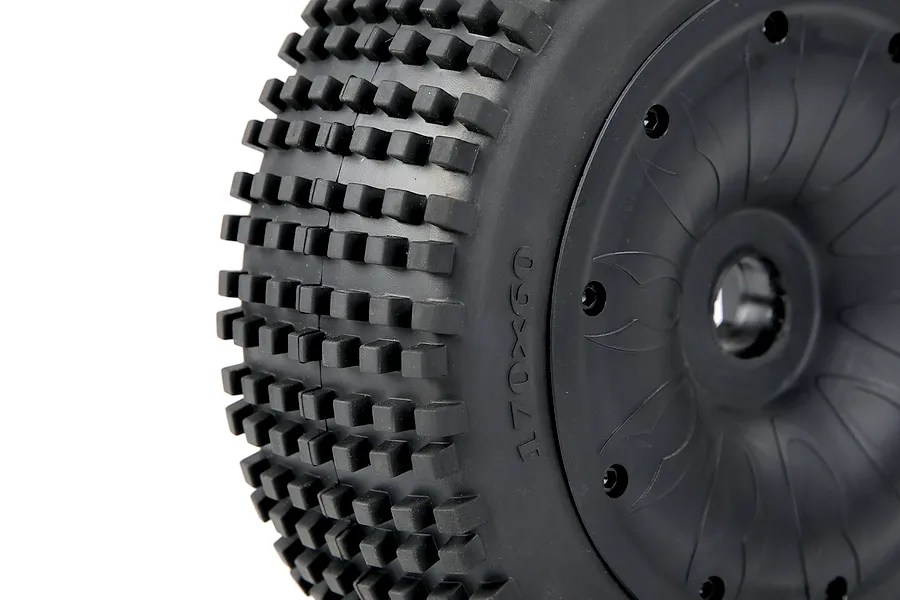 Close-up of a black 1/5 scale RC buggy tyre with square tread blocks mounted on a black closed-face beadlock rim.