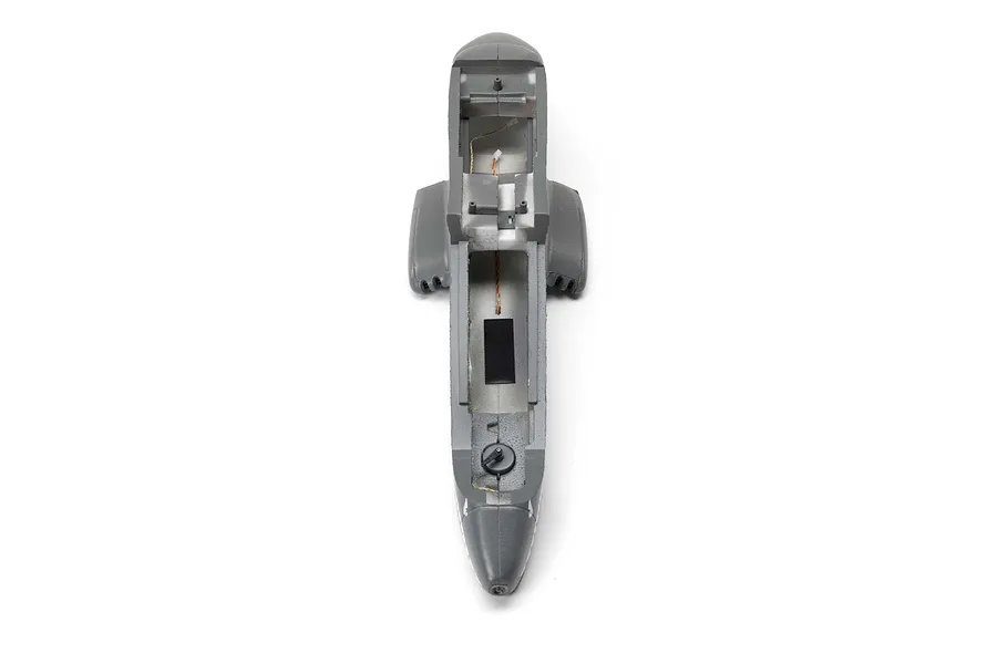 Top-down view of a grey foam RC airplane fuselage showing the internal cockpit and battery compartment area.