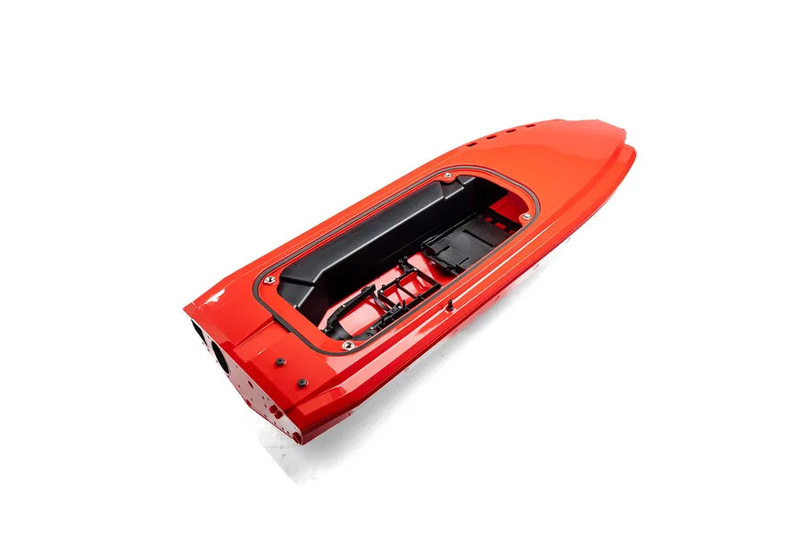 A bright red RC boat hull with an open cockpit area showing internal black plastic mounting structures against a white background.