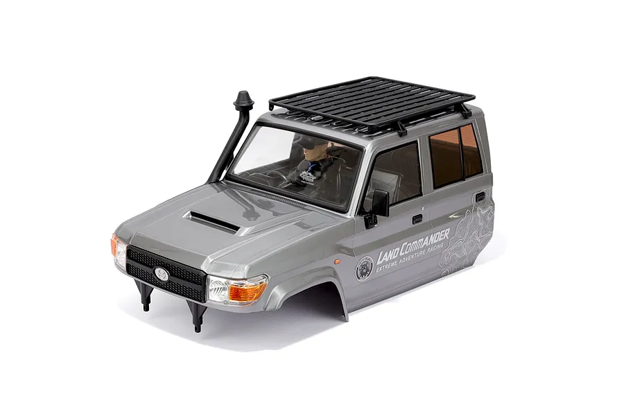 A grey RGT 1/10 scale LC79 Land Commander RC body shell with a black roof rack, snorkel, and driver figure, isolated on a white background.