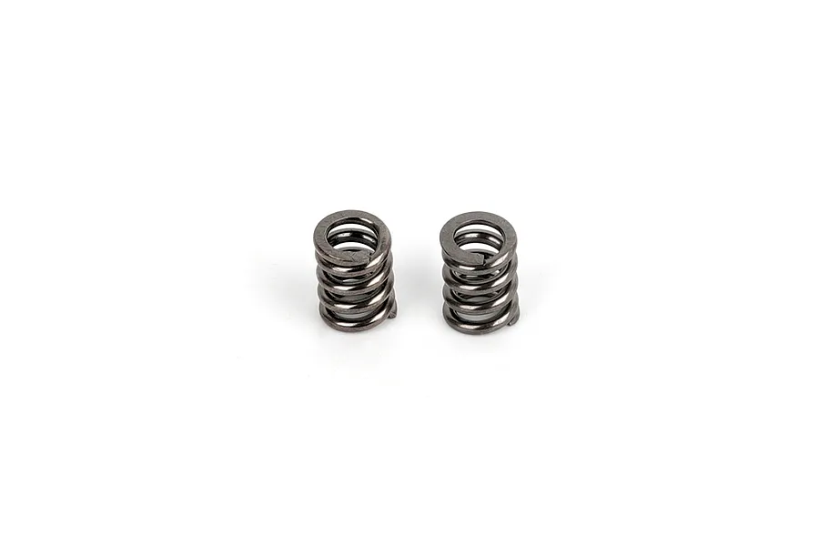 Two small, dark grey metal coil springs for an RC car drivetrain, shown side-by-side against a white background.