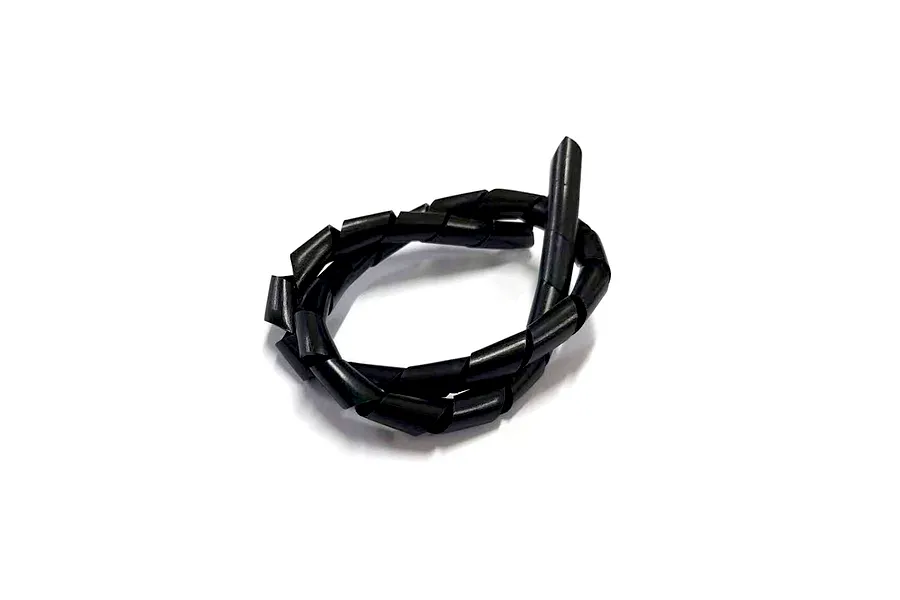 A coiled length of black plastic spiral cable wrap on a white background.