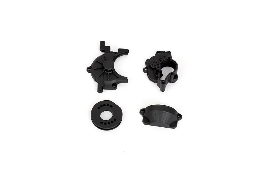 Four black plastic RGT transmission case components laid out on a white background.