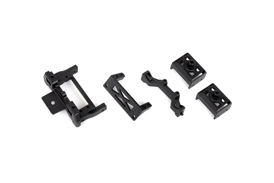 A set of black plastic RC car chassis mount components including a main frame, a brace, and two smaller mounting blocks.