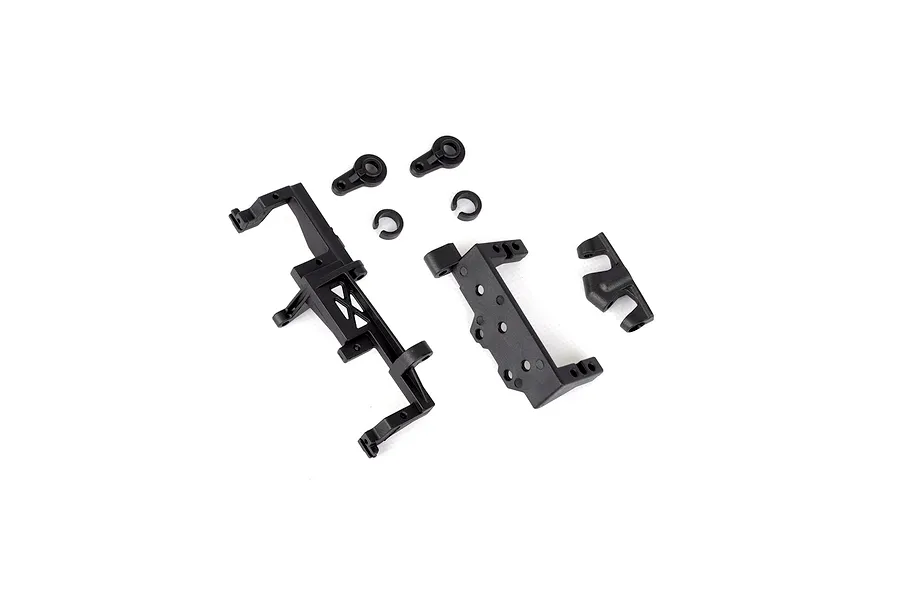 A set of black plastic RC servo mount components and small hardware pieces arranged on a white background.