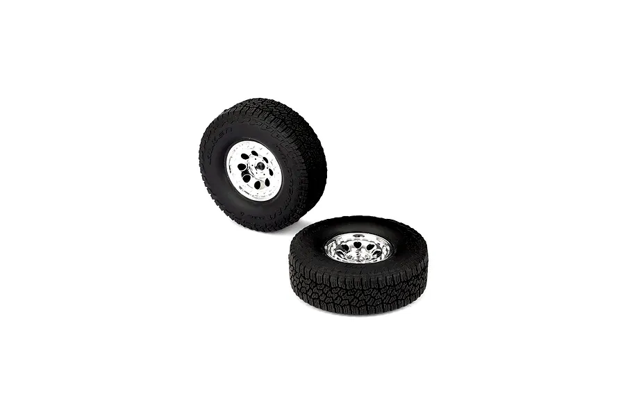 Two RGT 1/10 scale RC crawler wheels with black Wildpeak A/T rubber tires mounted on shiny silver rims against a white background.
