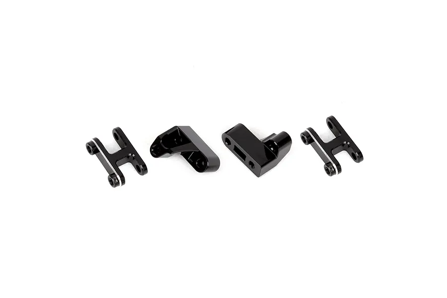 A set of four black aluminium RC shock mounts arranged on a white background.