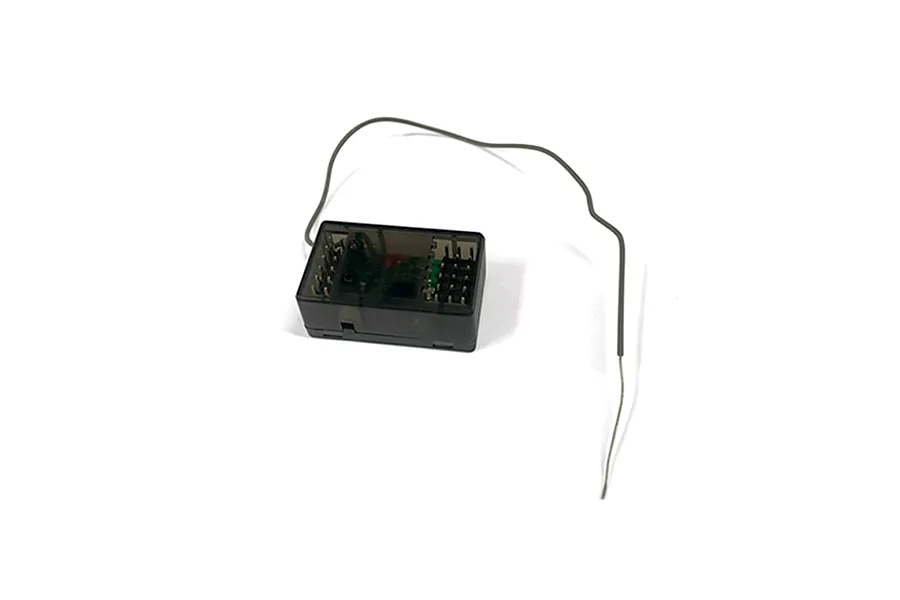 An RGT X6DC 2.4GHz RC receiver with a translucent black plastic case and a single external antenna wire, isolated on a white background.