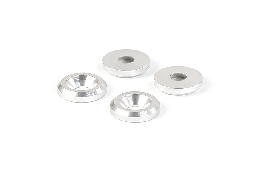 Four silver-coloured metal countersunk washers arranged on a white background.