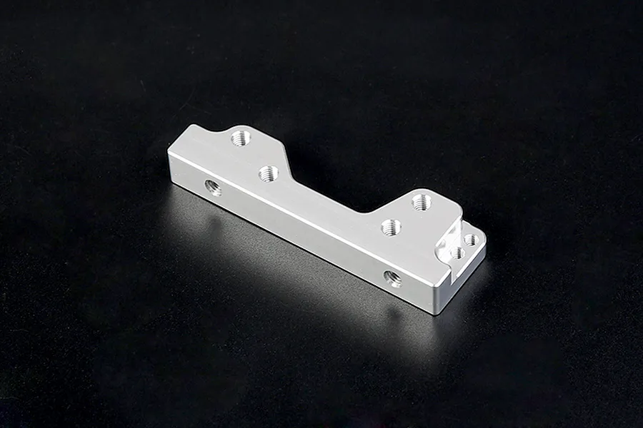 A silver Rovan aluminium engine mount for RC vehicles, featuring multiple pre-drilled screw holes, isolated against a dark background.
