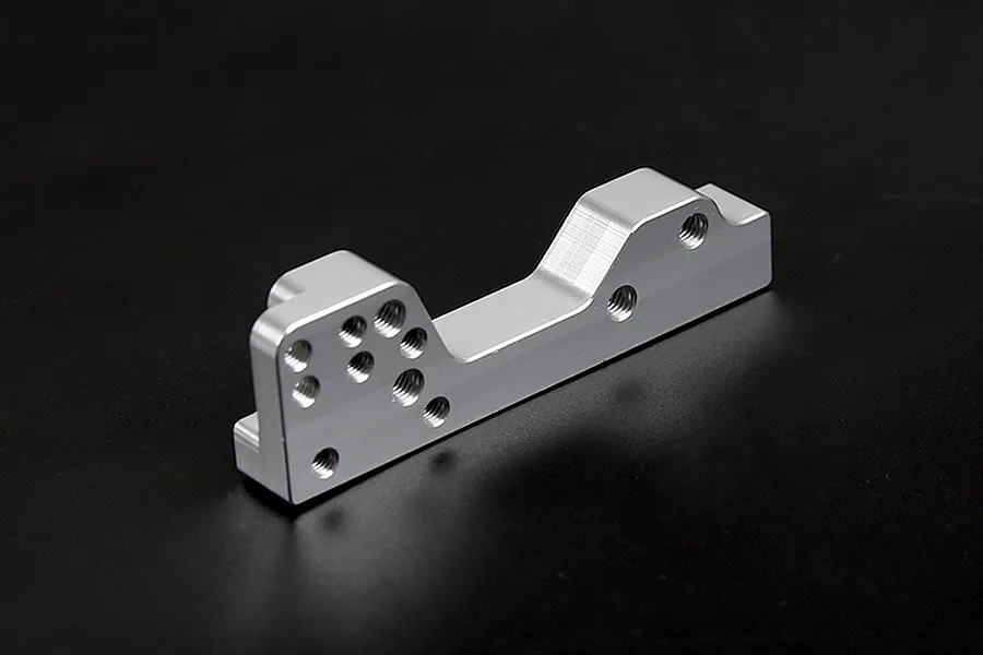 A silver Rovan aluminium engine mount for RC cars, featuring multiple pre-drilled screw holes, isolated against a dark background.
