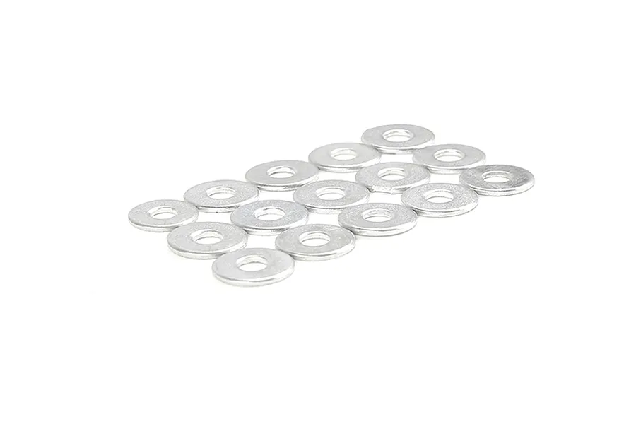 A collection of small silver metal washers arranged in a grid pattern on a white background.