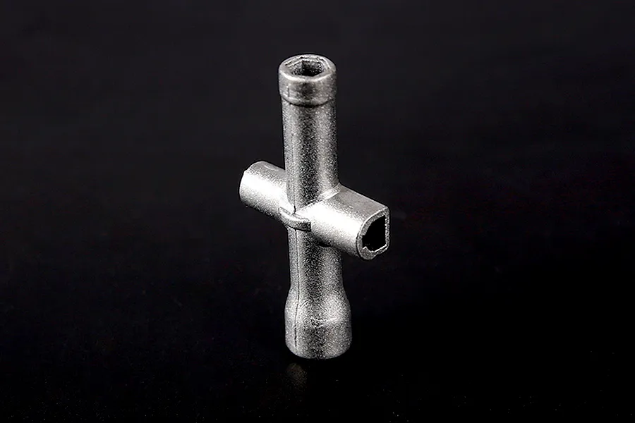 A silver-coloured metal cross wrench tool for RC vehicles, shown against a plain black background.