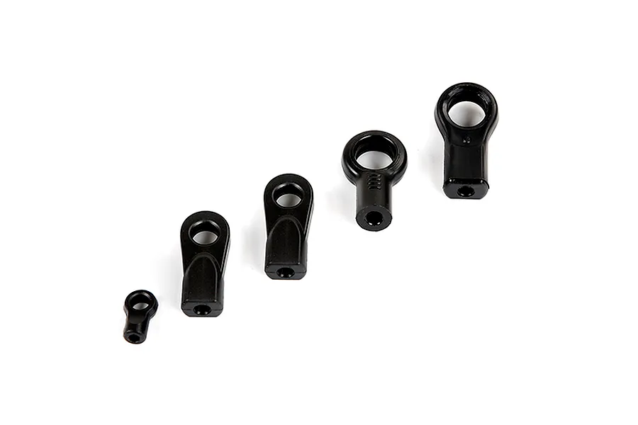 A set of five black plastic ball ends of varying sizes arranged in a diagonal line on a white background.