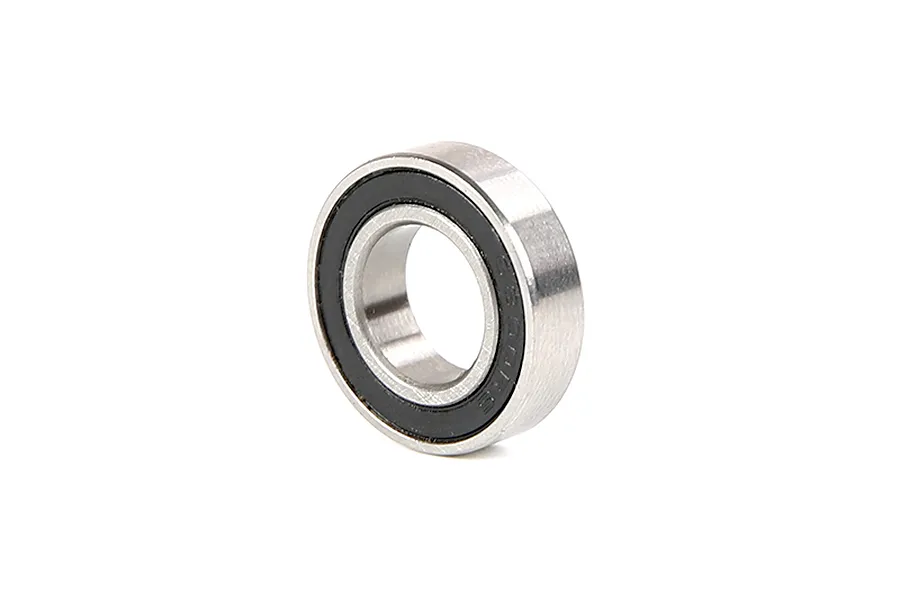A single metal ball bearing with a black rubber seal on one side, isolated on a white background.