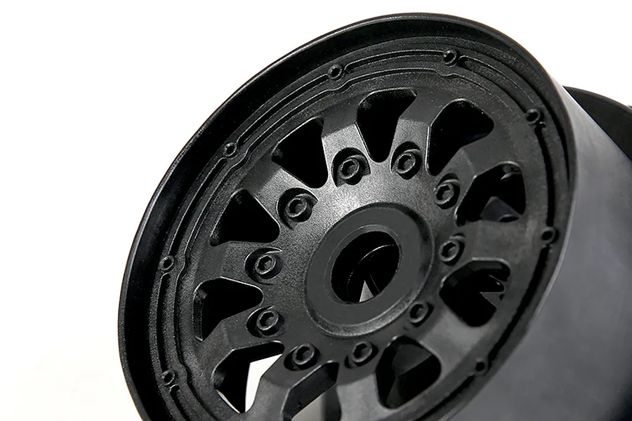 Close-up of a black Rovan RC wheel rim with a multi-spoke design against a white background.