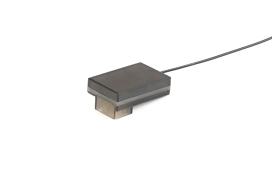 A black 2.4GHz RC receiver unit with a single antenna wire extending from the side, isolated on a white background.