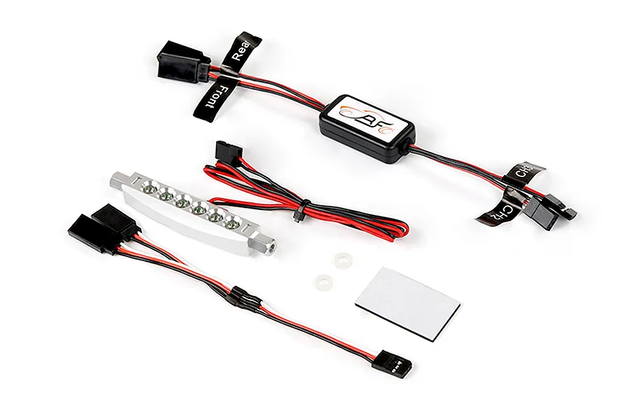 Rovan RC light controller kit with a silver LED light bar, wiring harnesses, and adhesive mounting pad on a white background.