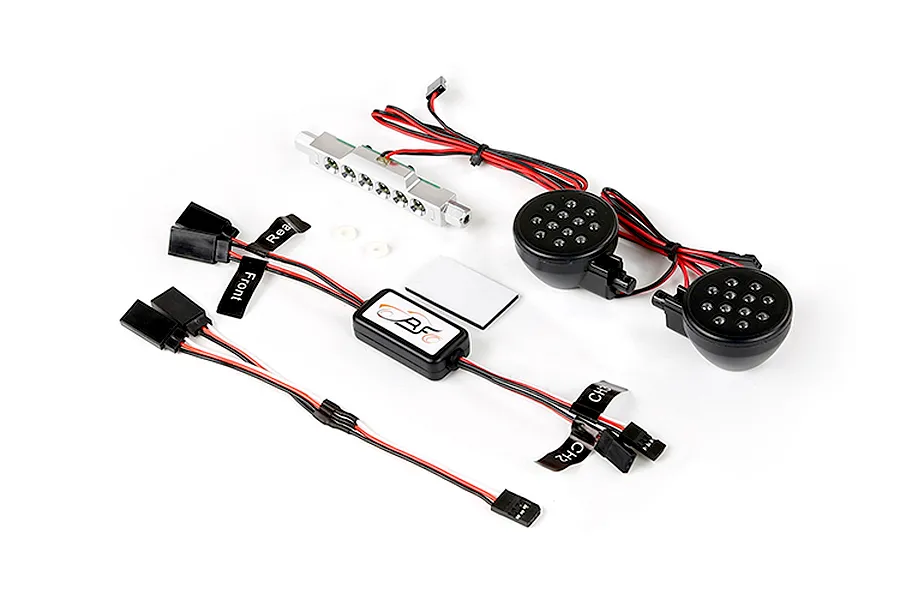Rovan RC light controller kit including a silver LED bar, two round black LED light pods, a control module, and wiring harnesses.