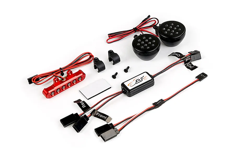 Rovan RC light controller kit including a red LED bar, two round black LED headlights, a control module, mounting brackets, and wiring harnesses.