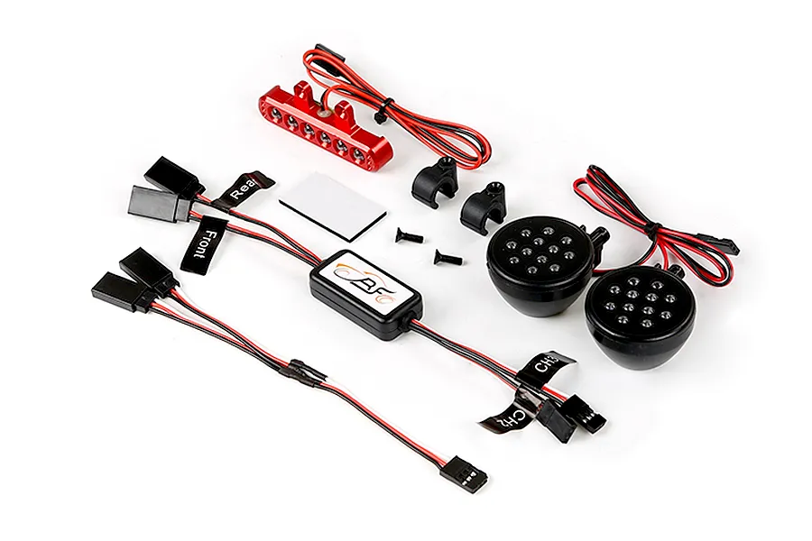 Rovan RC light controller kit including a central control box, two round LED headlight pods, a red LED light bar, wiring, and mounting hardware.